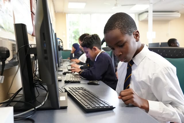 Pupils use computers during an ICT lesson.